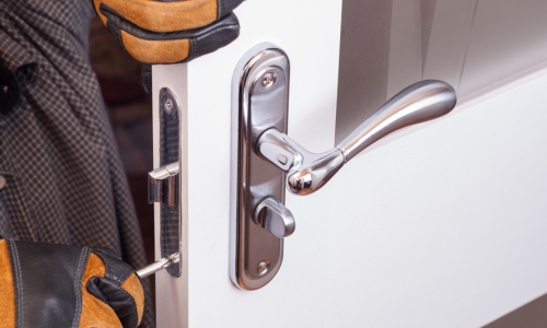 Contractor installing a door lock