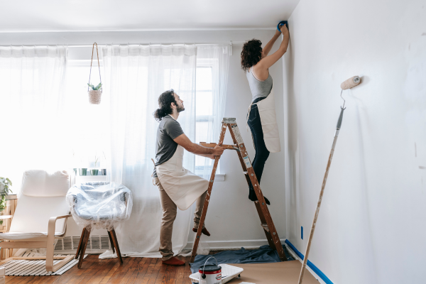 Couple painting a room together