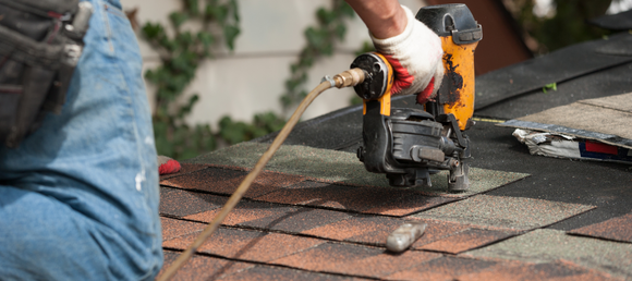 Contractor working on a shingle roof